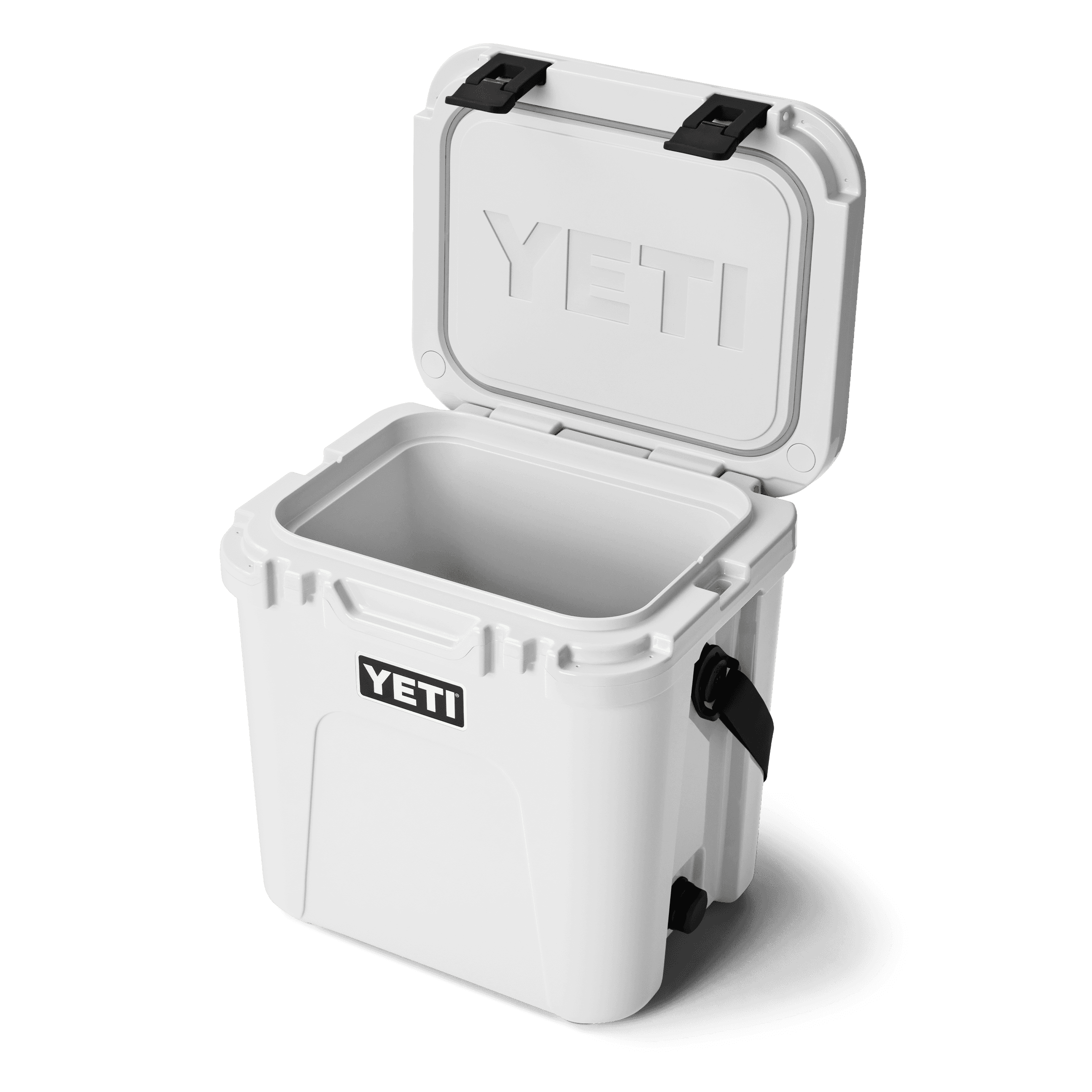 White YETI Roadie 24 hard cooler with the lid open, showing the empty interior and black rubber latches.